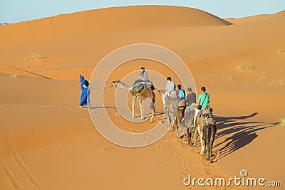 Tourist camel caravan in Africa sand desert dunes Editorial Stock Photo