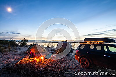 Tourist camping at the river on the sunset Stock Photo