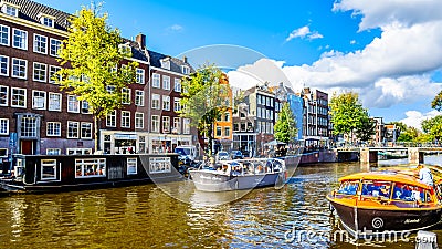 Tourist Canal Boats mooring at Anne Frank House at the Prinsengracht Prince Canal in the Jordaan neighborhood in Amsterdam Editorial Stock Photo