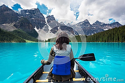 Tourist Canoeing on Moraine Lake in Banff National Park, Canadian Rockies, Alberta, Canada Stock Photo