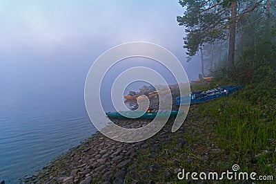 Tourist catamarans on the river bank in the morning mist Stock Photo