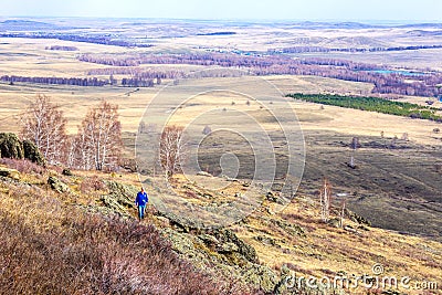 Tourist climbs uphill Stock Photo