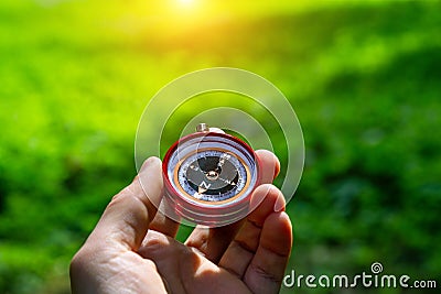 Tourist compass in his hand outdoors in the forest. Stock Photo