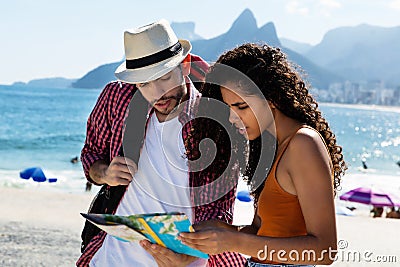 Tourist at Rio de Janeiro and brzailian woman looking at map Stock Photo