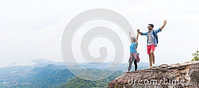 Tourist Couple With Backpack Holding Hands Raised On Mountain Top Enjoy Beautiful Landscape Panorama Stock Photo