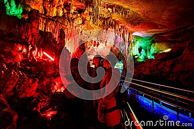 Tourist in underground cave Stock Photo