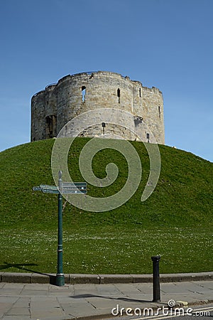 A tourist direction signpost by Cliffords's tower a stone monument in York UK Editorial Stock Photo
