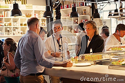 Tourist eating in the famous San Miguel Market in Madrid, Spain Editorial Stock Photo