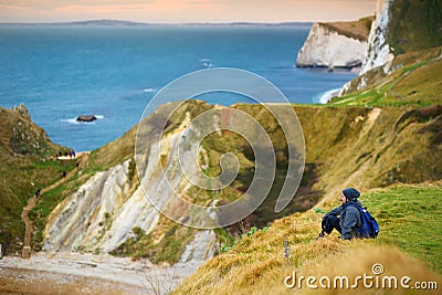 Tourist enjoying view of Man O`War Cove on the Dorset coast in southern England, between the headlands of Durdle Door to the west Stock Photo