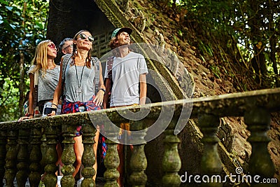 Tourist exploring ancient jungle ruins in tropical rain forest Stock Photo