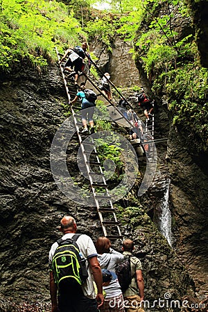 Tourists climbing iron ladders in Slovak Paradise Editorial Stock Photo