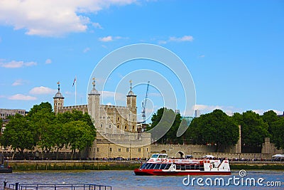 A tourist ferry transports tourists along the Thames river between the buildings and historic buildings of London Editorial Stock Photo