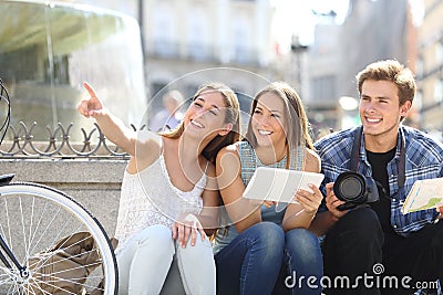 Tourist friends searching locations Stock Photo