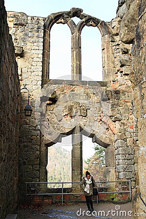 Tourist in front of ruin of Oybin castle and monastery Stock Photo