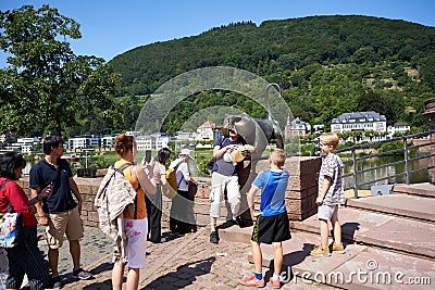 Tourists having fun at the famous Heidelberg Monkey on the banks of the Neckar River in Germany. Editorial Stock Photo