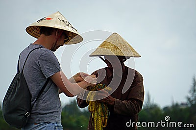 Tourist gets teached in traditional net fishing Editorial Stock Photo