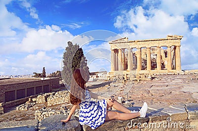 Tourist girl dressed in Greece flag colors looking at Parthenon Stock Photo