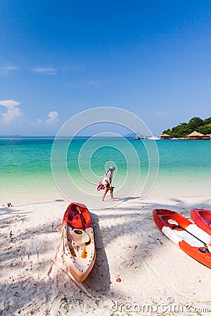 Tourist girl walks barefoot on the beach in summer Editorial Stock Photo