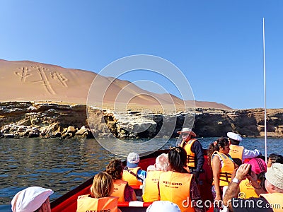 Tourist group in a boat near Candelabra of the Andes in Pisco Ba Editorial Stock Photo