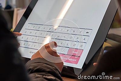 Tourist hand touching display at self-service transfer machine. Stock Photo