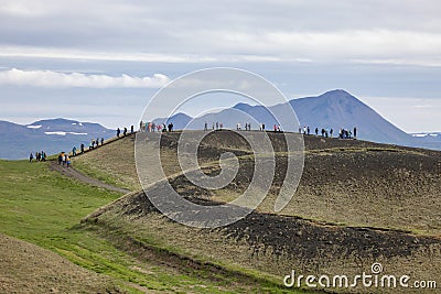 Tourist hike over pseudo craters near lake Myvatn in Iceland Stock Photo