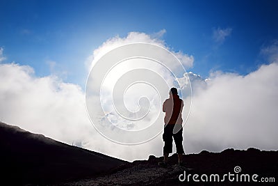 Tourist hiking in Haleakala volcano crater on the Sliding Sands trail. Beautiful view of the crater floor and clouds below. Maui, Stock Photo