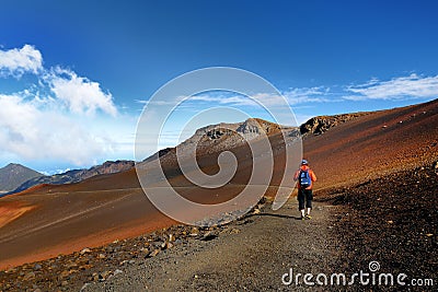 Tourist hiking in Haleakala volcano crater on the Sliding Sands trail. Stock Photo