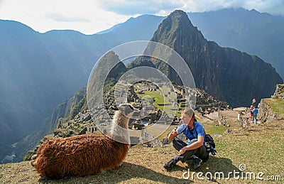 Tourist and llama in Machu Picchu Editorial Stock Photo