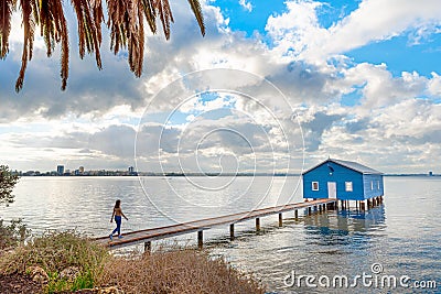 Tourist looking at famous little blue boat house - The Crawley Edge Boatshed Editorial Stock Photo