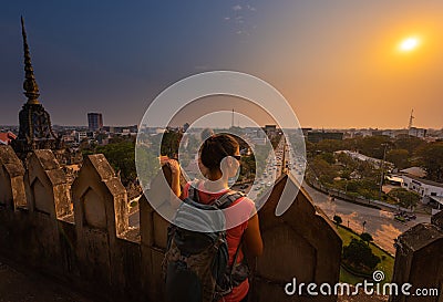 Tourist Looks at City of Vientane from the top of Patuxay Monument Laos Stock Photo