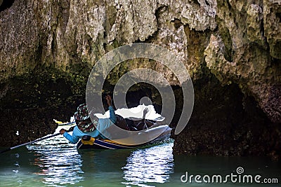 Tourist lying down through small cave, Phang Nga Editorial Stock Photo