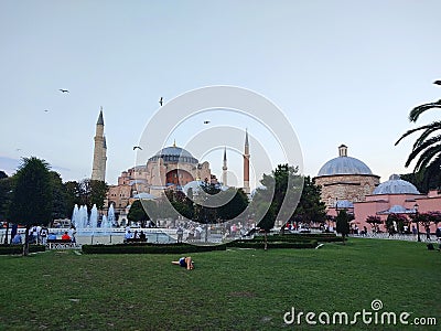 a tourist lying on the grass infront of the hagia sofya mosque,Istanbul, Turkey Editorial Stock Photo