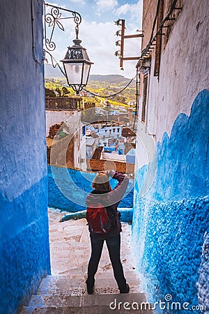 Tourist makes picture of Chefchaouen Blue city of Morocco Stock Photo