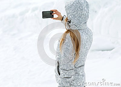 Tourist makes selfies on a high mountainside Stock Photo