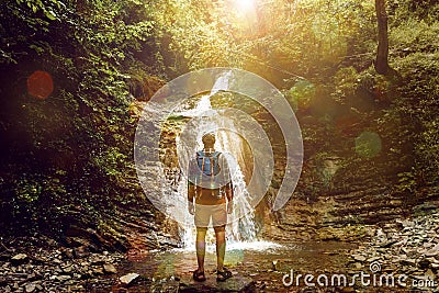 Tourist Man Reached Destination And Enjoys View Of Waterfall, Rear View, Contemplation Adventure Concept Stock Photo