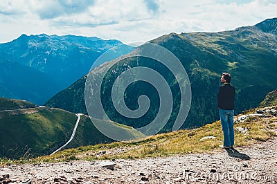 Tourist man standing on the top of mountain Stock Photo