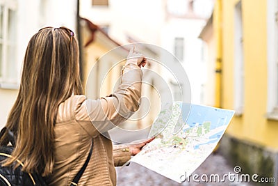 Tourist with map in the city. Woman pointing at right direction Stock Photo