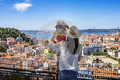 A tourist mother and her little daughter enjoy the view of the beautiful cityscape of Lisbon Stock Photo