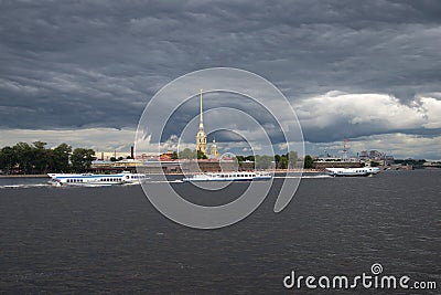 Tourist motor ships against the background of the Peter and Paul Fortress under the storm sky. Saint Petersburg Editorial Stock Photo