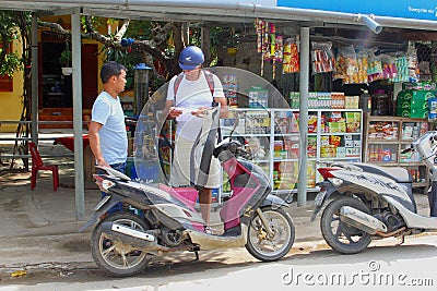 Tourist motorbike vintage petrol punp filling, Nhong Pha, Vietnam Editorial Stock Photo