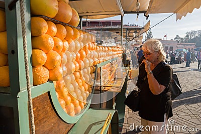 Tourist at Orange juice carriage at Place Djamaa el Fna Editorial Stock Photo