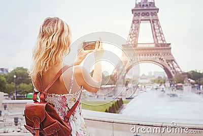 Tourist in Paris visiting landmark Eiffel tower, sightseeing in France, mobile photo on smartphone Stock Photo