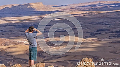 Tourist on the peak of Mount Negev are viewing a crater Makhtesh Ramon, Makhtesh Ramon, a geological phenomenon of Israel`s Negev Editorial Stock Photo