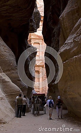 Tourist people walking at the entrance to petra monument through a rocky canyon , unesco world heritage site in Jordan Editorial Stock Photo