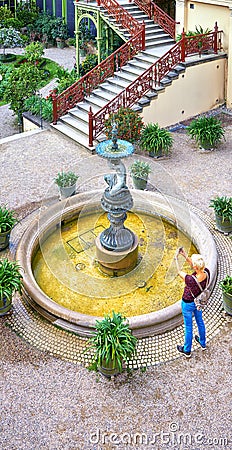 Tourist photographing the Schwerin Castle Fountain. Mecklenburg-Vorpommern, Germany Editorial Stock Photo