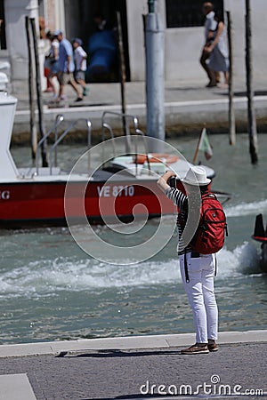 Tourist photographing Venice canals Editorial Stock Photo