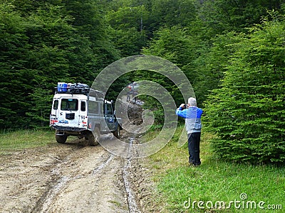 Tourist photographs a jeep on an impassable road, Tierra del Fuego, Argentina Editorial Stock Photo
