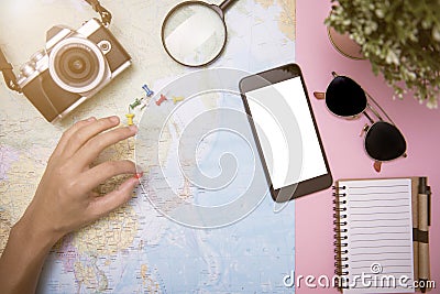 Tourist planning vacation with other travel accessories around. Stock Photo