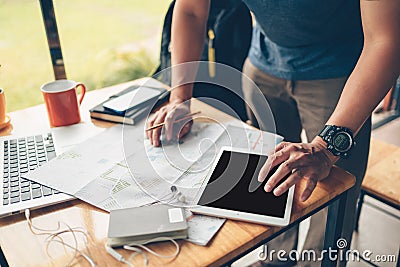 Tourist planning vacation use tablet for search and check hotel and travel accessories around on the table. Vocation, travel, Stock Photo