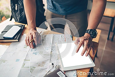 Tourist planning vacation use tablet for search and check hotel and travel accessories around on the table. Vocation, travel, Stock Photo